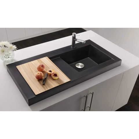 Modern kitchen sink with cutting board and fruit in upscale kitchen setting