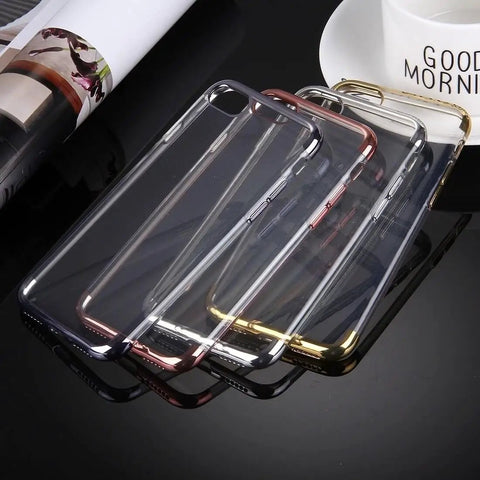 Four transparent phone cases with metallic edges in black, gold, silver, and rose gold on a reflective black surface.