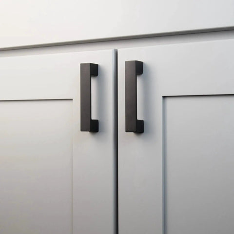 10 Pack Matte Black Kitchen Cabinet Handles Low Profile Drawer Pulls on white doors, showcasing modern square design and durable construction