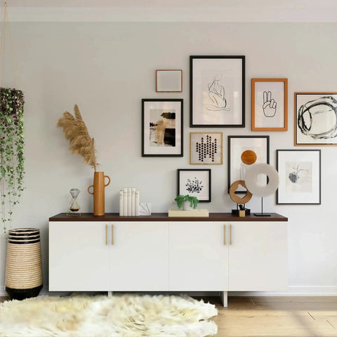 White sideboard with art gallery wall above, featuring Ten Pack 5 Inch Cabinet Handles With Champagne Bronze Finish For Kitchen Cupboards.