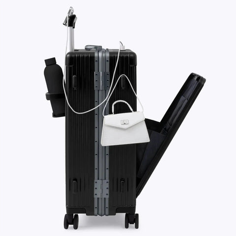 Side view of Zipperless Check In Suitcase With Aluminum Frame And Polycarbonate Shell For Ultra Durable Lightweight Travel At Just 11.1 Lb Jet Black Medium 27x17.5x10.4 Airline Approved TSA Locks 360 Degree Spinner Wheels By Nobl Travel, showing open interior with accessories.