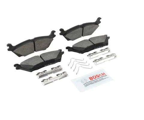 Rear view of Bosch BE2383H blue ceramic brake pad set with hardware, including pads, pins, springs and lubricant sachet.