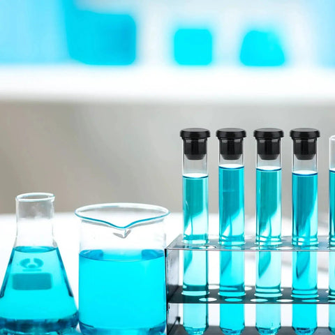 Test tubes with black caps in a rack, blue solution inside, showcasing 90 Pcs Silicone Rubber Hole Plugs Set In Assorted Sizes From 4mm To 9.5mm.