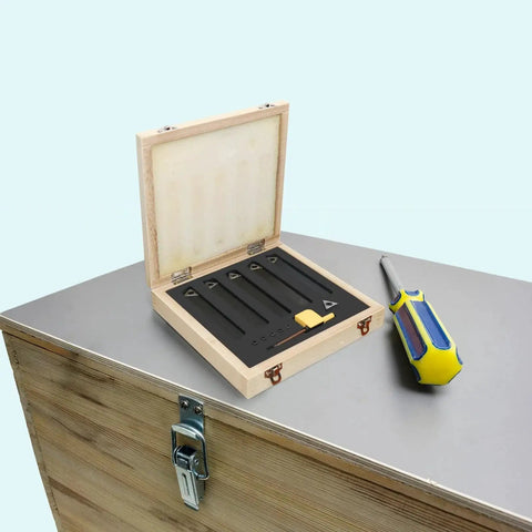 Five Sets Of Three Eighths Inch Carbide Lathe Tool Bits Kit For Metal Turning with wooden box and screwdriver on a table
