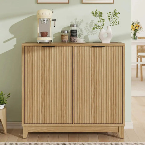 Front view of a fluted double tilt-out trash can cabinet with odor control and built-in outlets, used as coffee station.