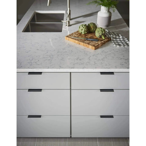 Modern kitchen with Mercer Collection Europa Tab Pull 3 Inch Length Brushed Satin Nickel Finish on cabinet drawers under marble counter