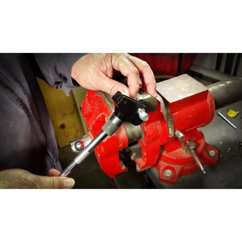 Universal Thread Repair Tool For SAE And Metric Threads With Adjustable Pitch being used on a metal vise for repair work