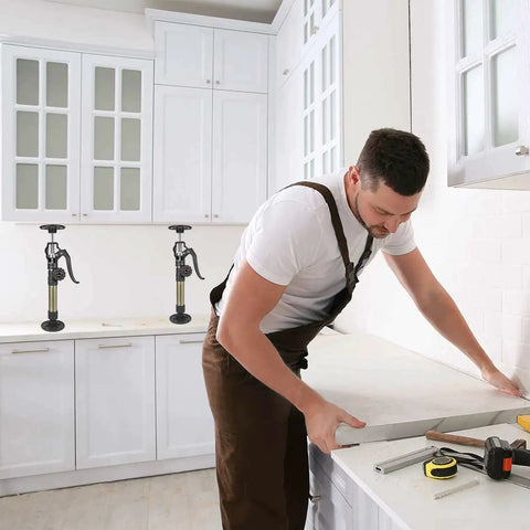 Man using Cabinet Jacks 3rd Hand Pole Extends 12.6 To 23.6 In Supports 156 Lbs 2 Pack for kitchen cabinet installation.