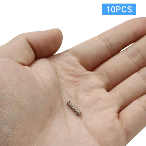 Stainless steel compression spring, 3 mm OD, 0.5 mm wire, 10 mm free length, silver; 10 pcs pack shown in palm