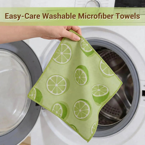 Person holding green microfiber cloth with lemon print in front of washing machine. 12 Pack Microfiber Cleaning Cloths For Cars And Home, Absorbent And Lint Free.