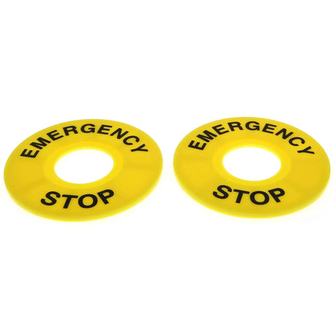 Yellow emergency stop labels for push button switches, used in industrial control panels and safety systems.