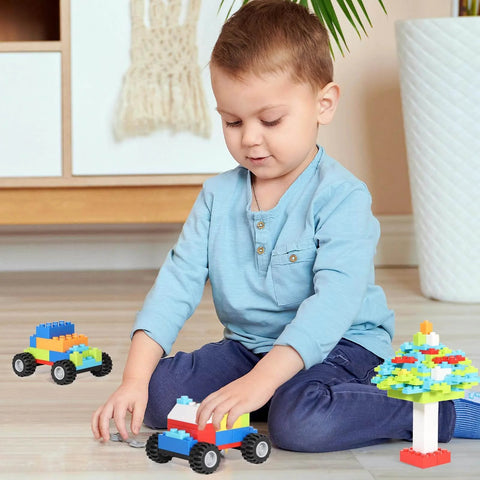 Child playing with Mega 1500 Piece Building Bricks Set For Kids With Doors, Windows, Wheels And Axles Includes 24 Big Wheels And 6 Doors