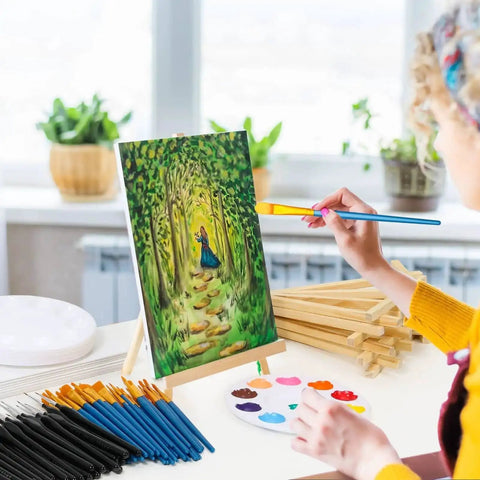 Person painting on canvas with 160 Piece Canvas With Easel Painting Kit Including Wooden Easel Blank Canvases 100 Brush Set
