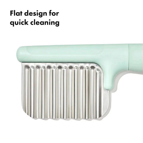 Close-up of Crinkle Cutter For Kids Safe Food Prep And On The Go Mealtime Fun With Easy Grasp Shapes, silicone handle and metal blade.