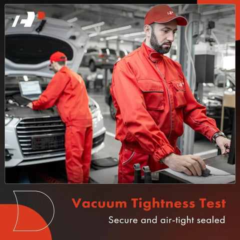 Mechanics in red uniforms performing vacuum tightness test on car in garage