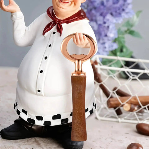 Close-up of a chef figurine holding a vintage-style stainless steel bottle opener with threaded flat opener handle.