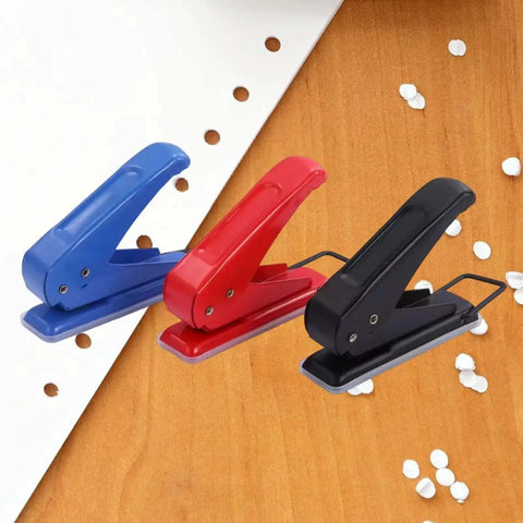 Go-To One Quarter Inch Single Hole Puncher With 20-Sheet Capacity in blue, red, black for school and office on wooden surface with punched holes
