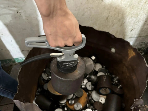 Person using Retractable Neodymium Magnetic Pickup Tool With Release Handle For Iron Plate to lift metal parts.