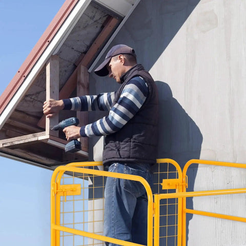 Worker using heavy-duty Forklift Safety Cage Work Platform 1200 Lb Load Capacity Collapsible With Wheels for roof repairs.