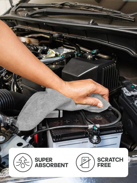 Person using 12x12 Inch Tear Away Microfiber Cloth Roll 40 Pack Reusable Washable Towels to clean car engine
