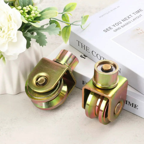 4 Pack 2.5 Inch Sliding Gate Wheels With 360 Degree Rotational Stem And V Groove Caster, displayed on a table with decorative items.