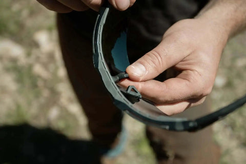 Tacana ANSI Z87.1 Safety Glasses for Men With Anti Fog Lenses being adjusted outdoors for a secure fit and comfort.