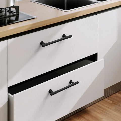Matte Black Cabinet Pulls 5 Inch Center To Center Zinc Alloy Kitchen Handles on white drawers, installed in modern kitchen setting