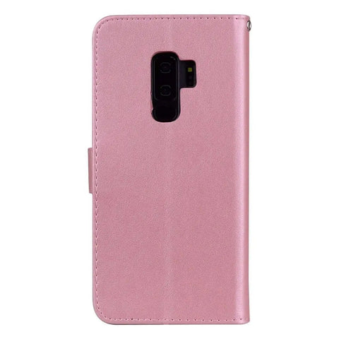 Pink leather phone case with camera cutout, standing upright, showcasing durable material and precise design for smartphone protection.