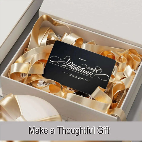 Gift box featuring Fifty Pcs Matte Black Metal Business Card Blanks For Laser Engraving, surrounded by gold ribbon.