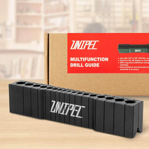 Precision Drill Guide For Straight Holes Compact Portable Drilling Block For Wood Metal And Plastic SAE One Eighth To Three Eighths Inch Sizes Keeps Drill Bits Aligned For Cleaner And More Accurate Holes on a table in front of packaging.