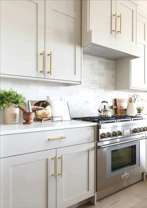 Modern kitchen with 10 Pack Brushed Gold Cabinet Pulls 5 Inch 128mm Solid Heavy Duty Zinc Alloy Drawer Handles installed on white cabinets.