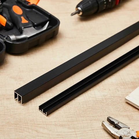 Two Pack 3 Foot Black Aluminum Sliding Door Track Set For Quarter Inch Thick Panels Ideal For Closet Glass Doors Cabinets And Windows Durable Aluminum Alloy Construction Easy Install With Nails Glue Or Tape Cut To Length on wooden surface with tools