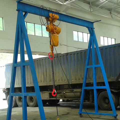 Front view of blue steel gantry crane with a yellow electric hoist and red-hook chain sling for lifting
