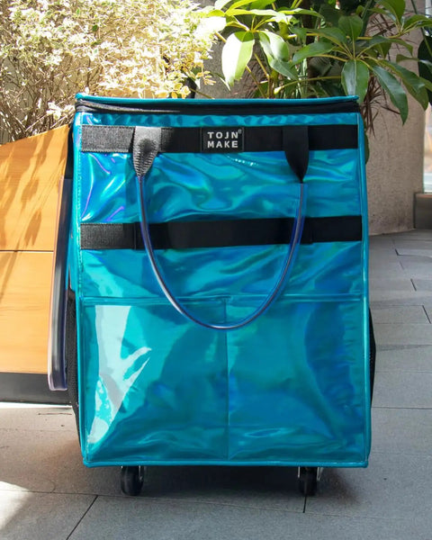 Front view of Glitter Blue Rolling Grocery Tote With Wheels And Zipper Covered 8 Pocket Organizer Foldable Durable Tote.