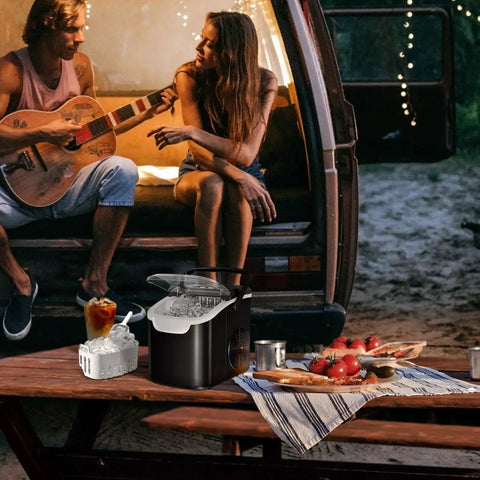 Portable Countertop Ice Maker With 26lb Daily Capacity And Two Ice Size Options on picnic table, campers in background