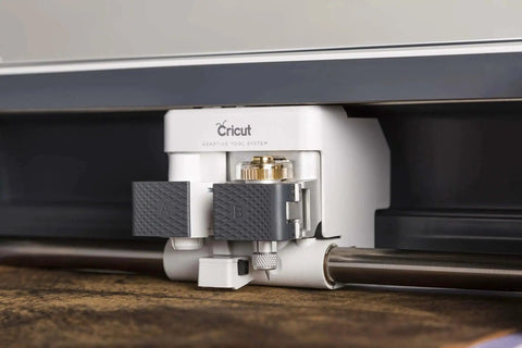 Close-up of knife blade and drive housing installed in Cricut Maker machine for cutting wood, leather, and chipboard.