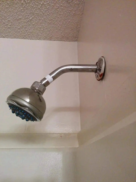 Installed showerhead with visible Pro Grade PTFE Thread Seal Tape For Plumbers 1 Inch By 520 Inch Go To Leak Proof Sealant.