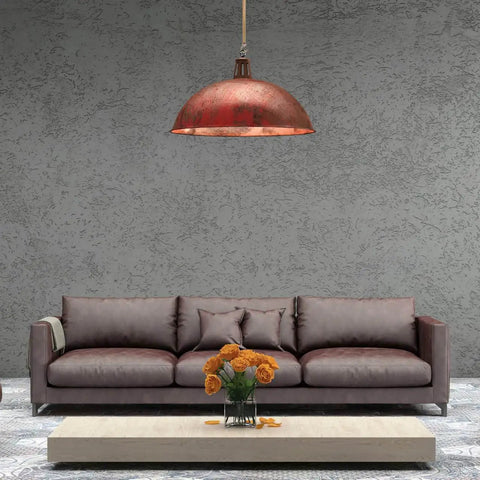 Living room with large brown sofa, industrial red pendant light, and low wooden table with orange flowers.