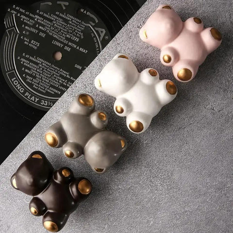 Lovely Teddy Bear Ceramic Cabinet Knobs 2 Pack For Cabinets And Drawers displayed in white, gray, and brown with gold accents.