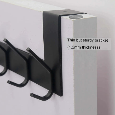 Close-up of Over The Door Hooks Towel Rack With 6 Hooks, black, showing sturdy bracket on white door.