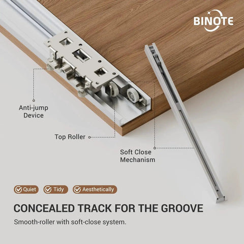 Close-up of concealed sliding barn door hardware showing aluminum track, top roller, and soft close mechanism for interior doors.