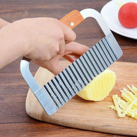 Crinkle Cut French Fry Slicer With Stainless Steel Blade And Ergonomic Wooden Handle slicing potato on cutting board