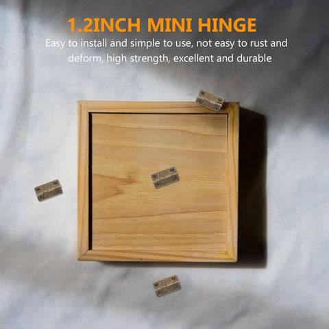 1.2 Inch Miniature Iron Chest Hinges With Screws 50 Pack for Small Cabinets Jewelry Boxes DIY Crafts, shown with wooden box.