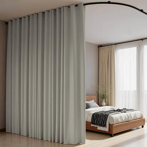 Flexible Ceiling Track Curtain System For L Shaped Or U Shaped Installations with blackout panels in light grey dividing bedroom.