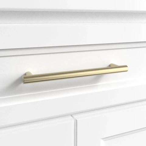 Door And Drawer Pulls 6-Inch Center-To-Center Brushed Titanium Gold Finish 10 Pack for cabinets and furniture upgrades on a white drawer.