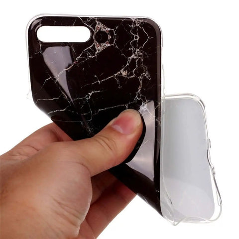 Hand holding black marble-style flexible phone case
