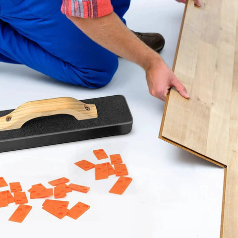 Installer using Beefy Pro Grade 4 In 1 Laminate And Vinyl Flooring Installation Kit with spacers, pull bar, and tapping block.