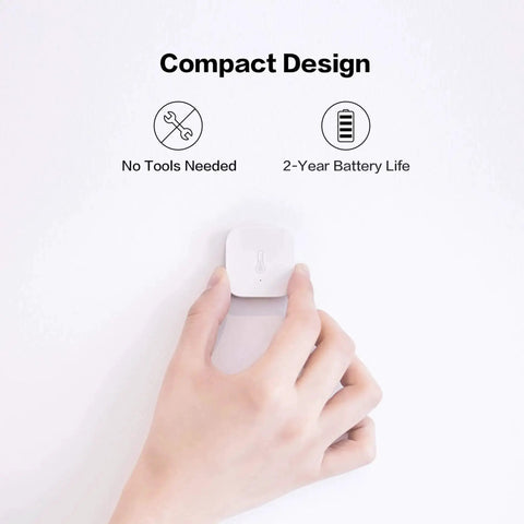 Hand holding Zigbee Temperature And Humidity Sensor For Home Automation With Wireless Thermometer Hygrometer Remote Monitoring