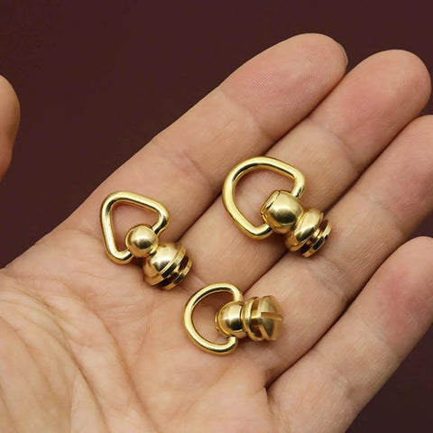 Solid Brass Ball Stud Rivets With D Ring 360 Rotatable Head For Leather Purses shown in a hand, highlighting size and material.