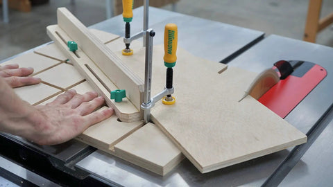 Woodworker using Matchfit Dovetail Clamp Pro Router Bit Kit With One Half Inch Shank And Fourteen Degree Bit for precision routing.